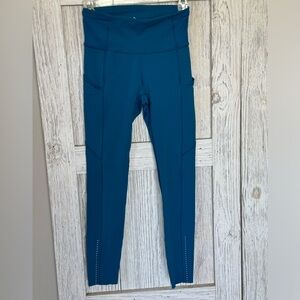 Lululemon Leggings size 4 teal color with small hole on inside of leg by seam.
